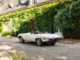 a white convertible car parked in front of a house