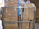a cart full of boxes in a warehouse with a man standing in the background