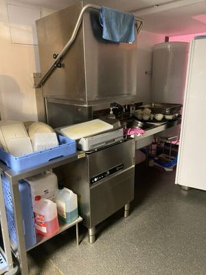 a kitchen with a stove, sink, and refrigerator in it