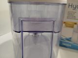 a plastic container sitting on a counter next to a box of hygie