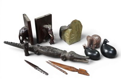 a group of objects that include an alligator, a bookend, a pencil, and a pair of scissors