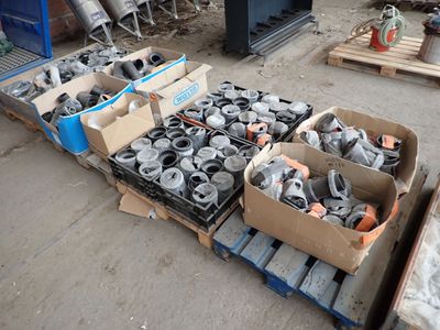 several boxes of assorted metal items on a pallet in a warehouse