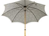 a black and white umbrella with a wooden handle on a white background