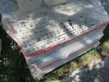 a stack of books wrapped in plastic on the ground