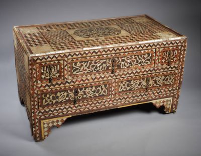 a wooden chest with a geometric design on the front