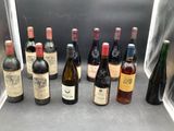 several bottles of wine are lined up on a counter