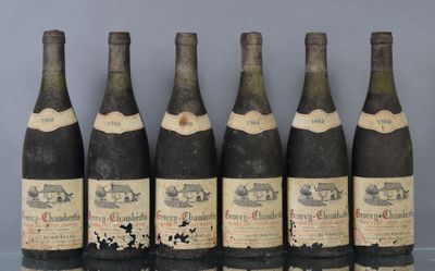 six bottles of wine are lined up on a table