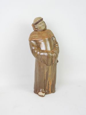figurine of a monk in a brown robe and hat