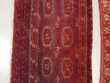 two red rugs are sitting on a white surface