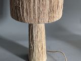 a wooden lamp that is on a table with a rope