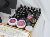 many bottles of nail polish in a gold box