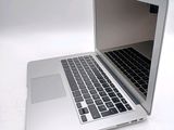 a laptop computer that is sitting on a white surface
