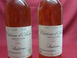 two bottles of wine sitting next to each other on a table
