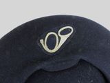 a black hat with a gold emblem on it