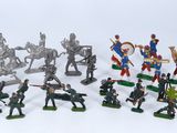 a lot of toy soldiers that are on a white surface