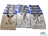 many shirts that are wrapped in plastic bags on the table