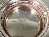 a silver bowl with a silver lid sitting on a table