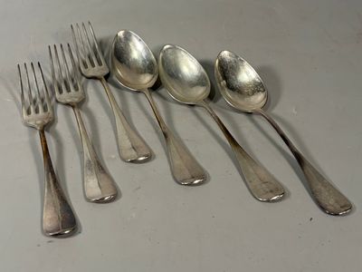 five spoons and a fork on a table