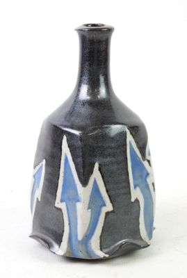 a black vase with blue and white designs on it