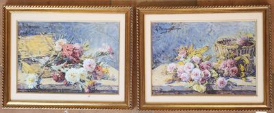 two paintings of flowers are hanging on a wall in a room