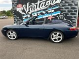 a picture of a blue sports car parked in a parking lot