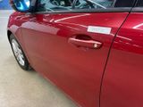 a red car that has a sticker on the side of it