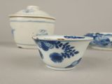 two blue and white bowls and a small bowl on a table