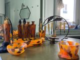 a table with a lot of orange and brown glass items on it