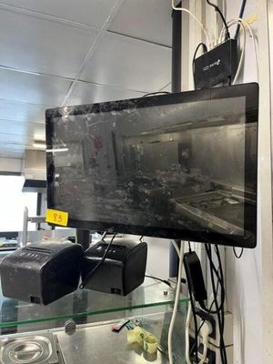 a television that is on a glass shelf in a room