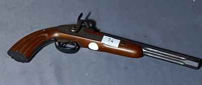 an old gun with a tag on it laying on a table
