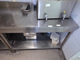 a stainless steel counter with a toaster on it