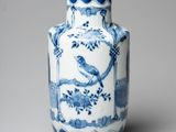 a blue and white vase with a bird on it