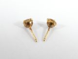 a pair of gold stud earrings on a white surface