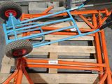 an orange and blue cart sitting on top of a pallet in a warehouse
