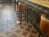 tiled floor in a restaurant with stools and a bar