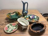 a wooden table topped with bowls and plates on it