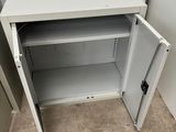 a white cabinet with a door open in a room