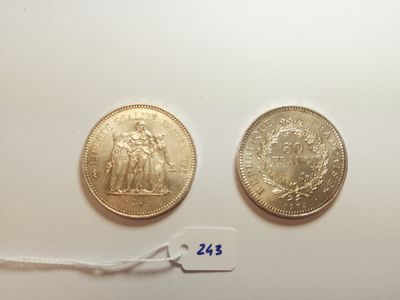 two gold coins with a price tag on a white surface