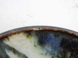 a close up of a blue and white bowl on a table