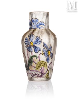 a glass vase with blue flowers painted on it