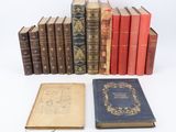 an assortment of old books sitting on top of each other