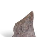 a stone sculpture of a triangular shape on a white surface