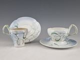 two cups and saucers with a saucer and saucer on a table