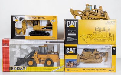 three different models of construction vehicles in the box
