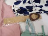 a belt that is attached to a dress on a bed