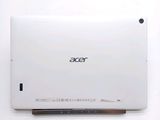 the back of a white laptop computer sitting on top of a white table