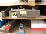 a shelf with a bunch of boxes and other items on it