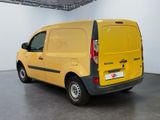 the back of a yellow van parked in a large room