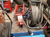 a blue cart with a hose and a blue cart with a hose on it