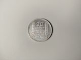 a close up of a silver coin on a white surface